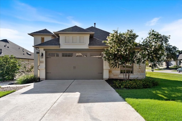 view of front facade with a garage and a front yard