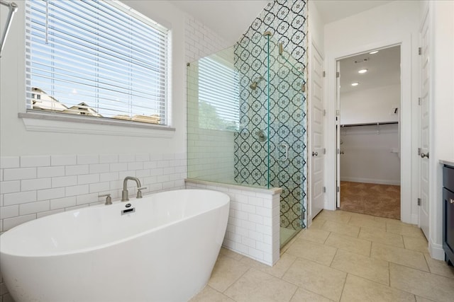 bathroom with a washtub and tile patterned floors