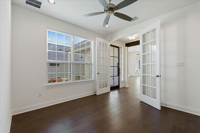 unfurnished room featuring dark wood-type flooring, a healthy amount of sunlight, french doors, and ceiling fan