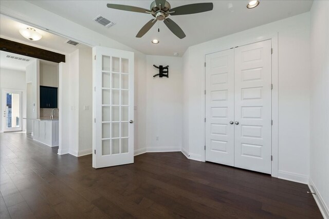 unfurnished bedroom featuring dark hardwood / wood-style floors, french doors, a closet, and ceiling fan