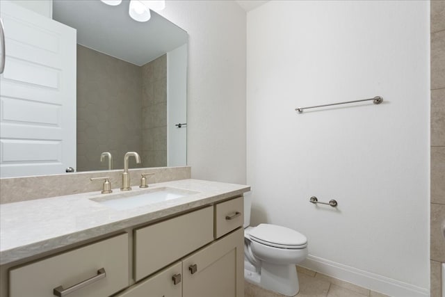 bathroom with vanity, tile patterned floors, and toilet