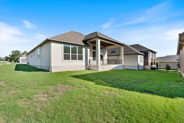 rear view of property featuring a yard