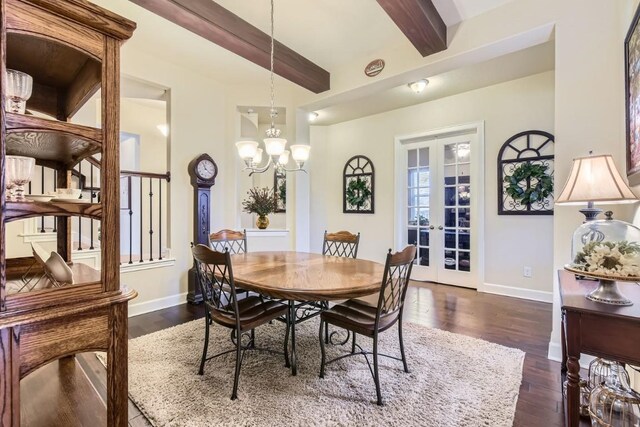 dining space with beam ceiling, french doors, dark hardwood / wood-style flooring, and a chandelier