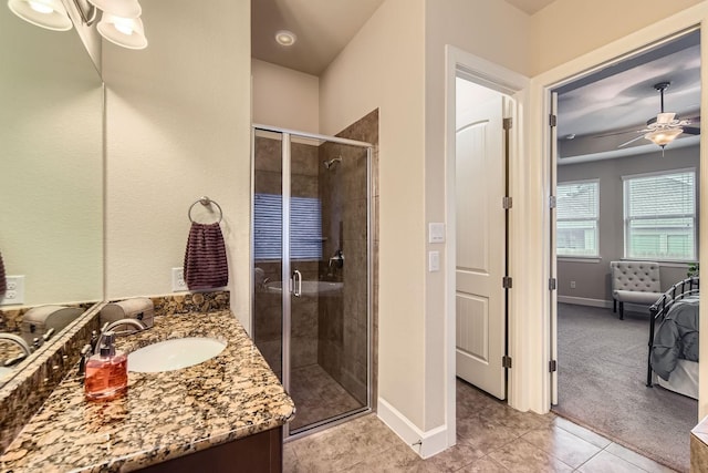 bathroom with vanity, ceiling fan, tile patterned flooring, and an enclosed shower