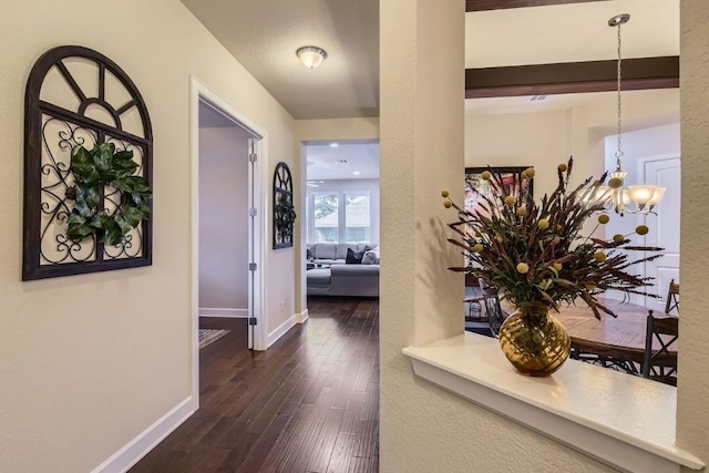 hallway with baseboards and dark wood-style flooring