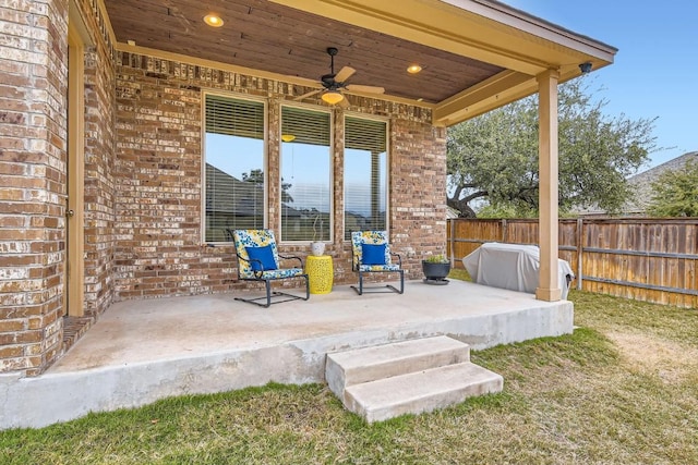 view of patio featuring fence and a ceiling fan