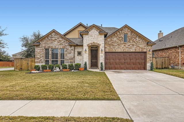 french country style house featuring a front lawn, concrete driveway, fence, and an attached garage