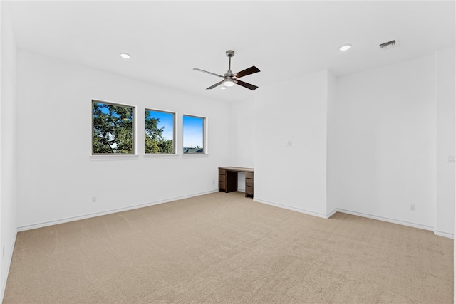 carpeted spare room featuring ceiling fan