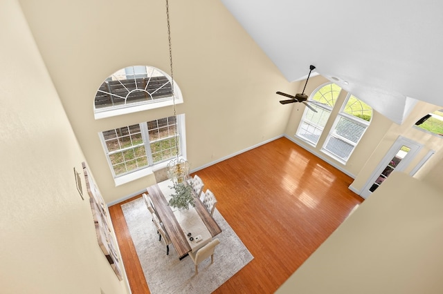 living room featuring hardwood / wood-style flooring, high vaulted ceiling, and ceiling fan