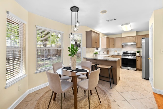 tiled dining space featuring sink