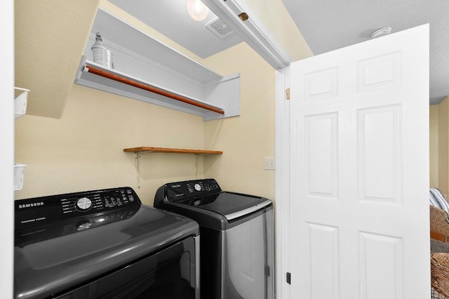 clothes washing area with washing machine and clothes dryer