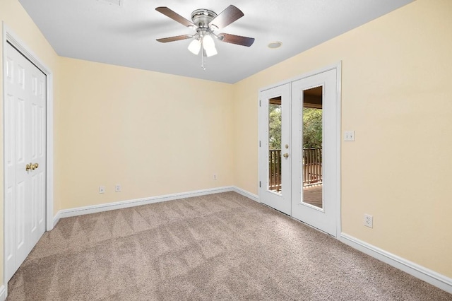 carpeted empty room with ceiling fan and french doors