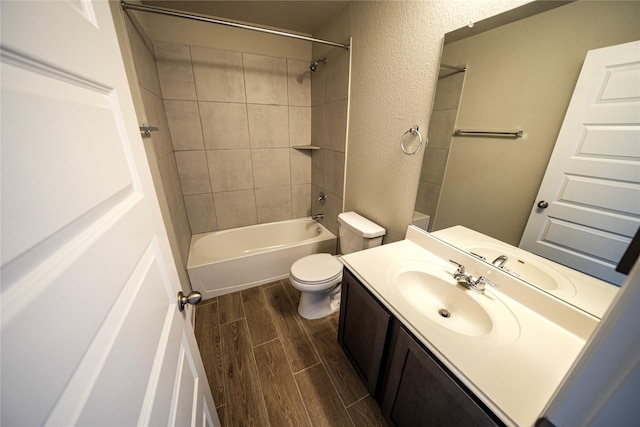 full bathroom with vanity, toilet, and tiled shower / bath combo