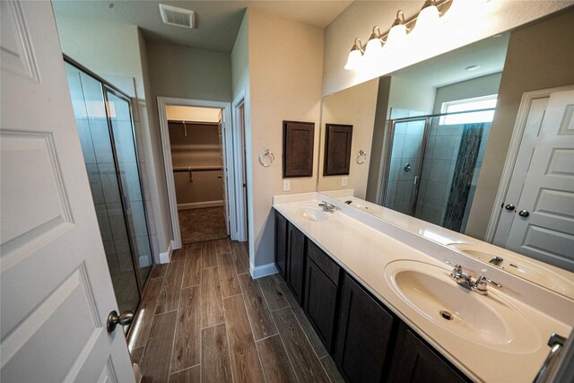 bathroom featuring vanity and a shower with shower door