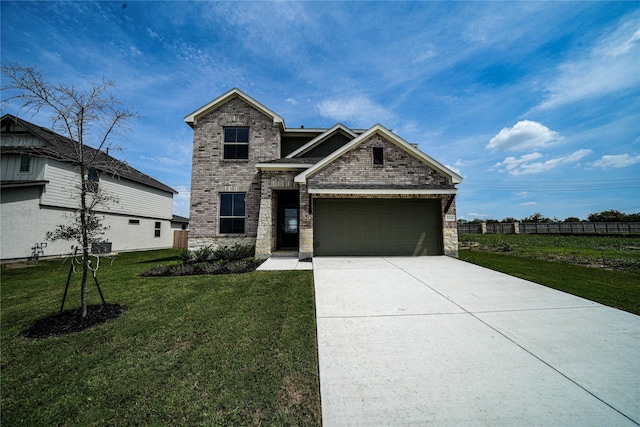 view of front of property featuring a front yard and a garage