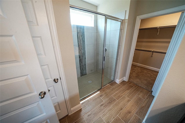 bathroom featuring a shower with shower door