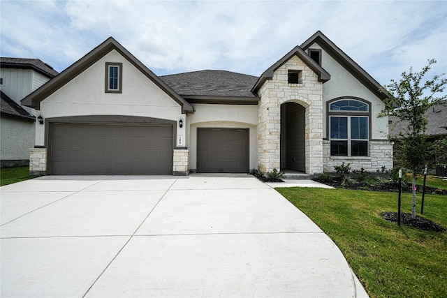 french country home with a garage and a front yard