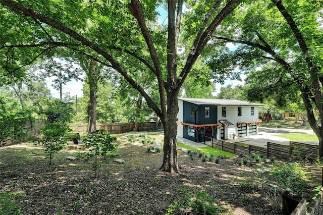 exterior space with a garage and a fenced backyard