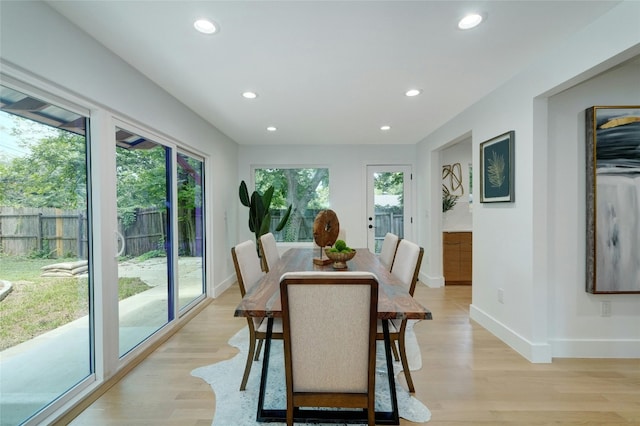 dining area with a wealth of natural light, light wood-style flooring, and recessed lighting