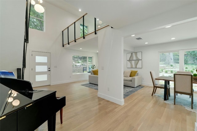 interior space with light wood finished floors, visible vents, and baseboards