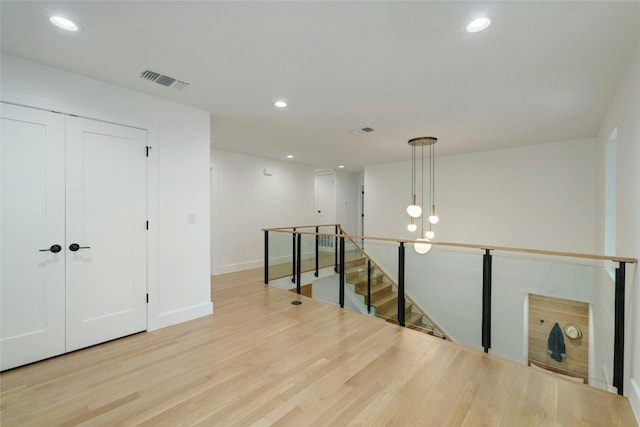 spare room with light wood-style floors, baseboards, visible vents, and recessed lighting