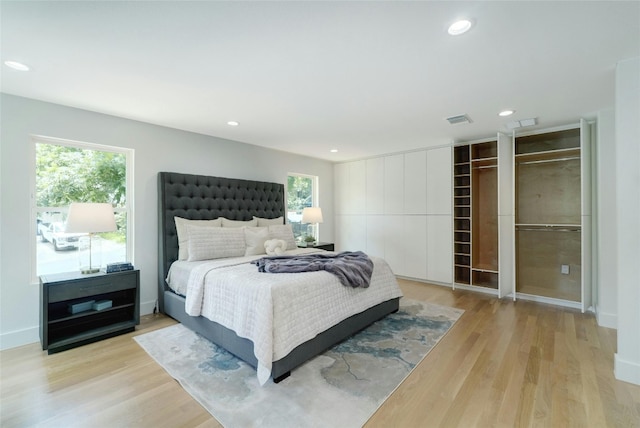 bedroom featuring light wood-type flooring, visible vents, and recessed lighting