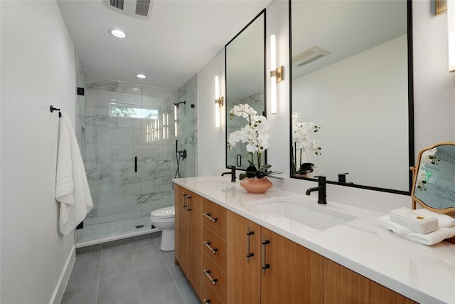 bathroom featuring vanity, toilet, an enclosed shower, and tile patterned floors