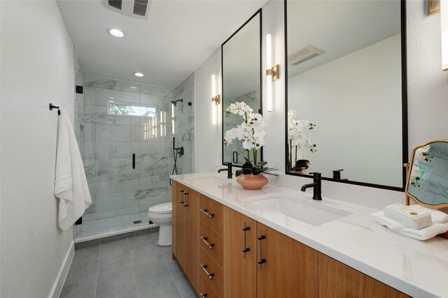 3104 Santa Monica Dr, Austin, TX 78741 - bathroom with double vanity, a shower stall, toilet, baseboards, and tile patterned flooring