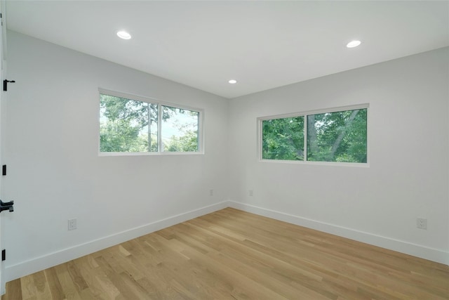 3104 Santa Monica Dr, Austin, TX 78741 - spare room featuring healthy amount of natural light, baseboards, light wood-style floors, and recessed lighting