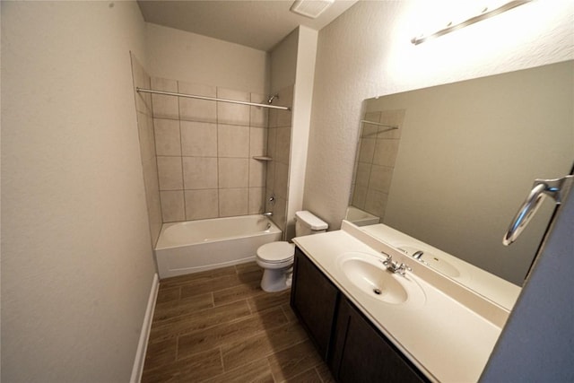 full bathroom featuring bathtub / shower combination, toilet, wood finish floors, vanity, and baseboards