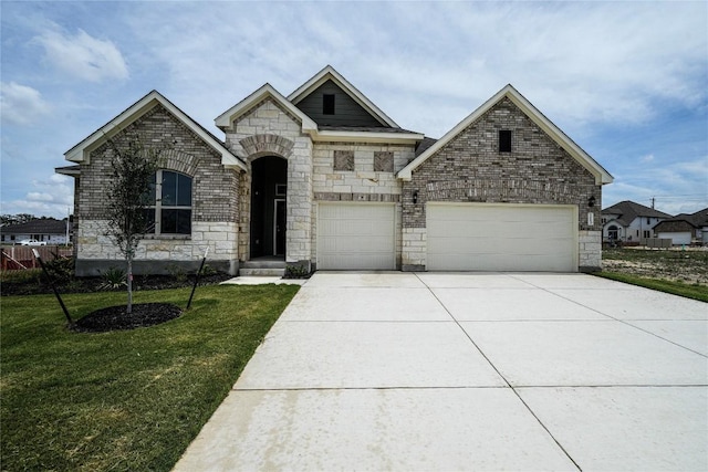 view of front of property with a garage, brick siding, driveway, and a front lawn