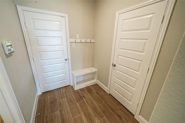 interior space featuring dark wood finished floors and baseboards