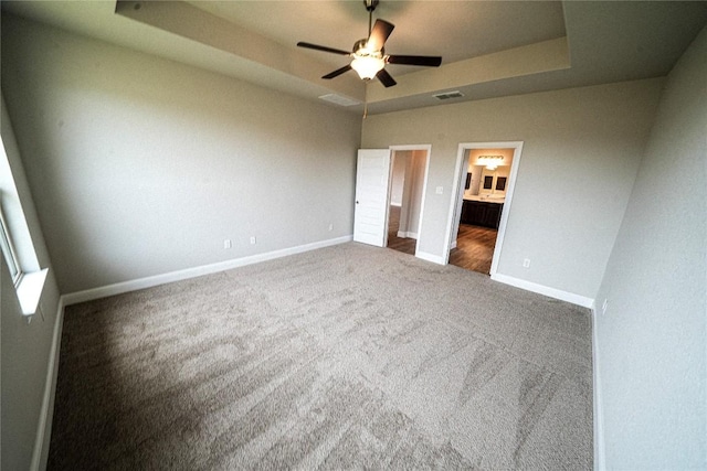 213 Fillmore Fls, Cibolo, TX 78108 - unfurnished bedroom featuring a raised ceiling, carpet, baseboards, ensuite bathroom, and ceiling fan