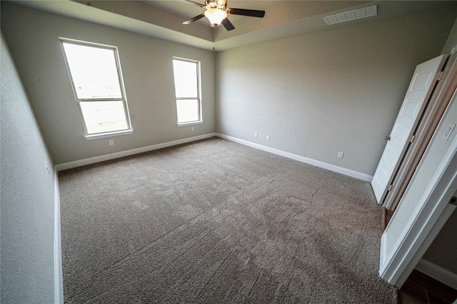 unfurnished bedroom with carpet, visible vents, and baseboards