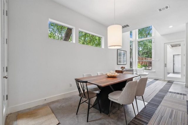 dining space with a wealth of natural light, baseboards, and visible vents