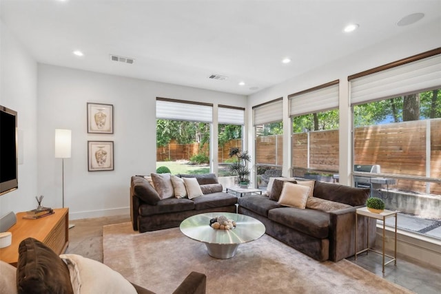 living room with baseboards, visible vents, and recessed lighting