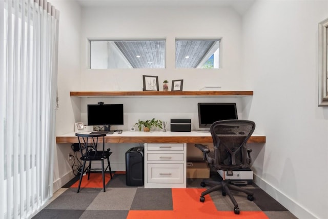 office with baseboards and built in study area