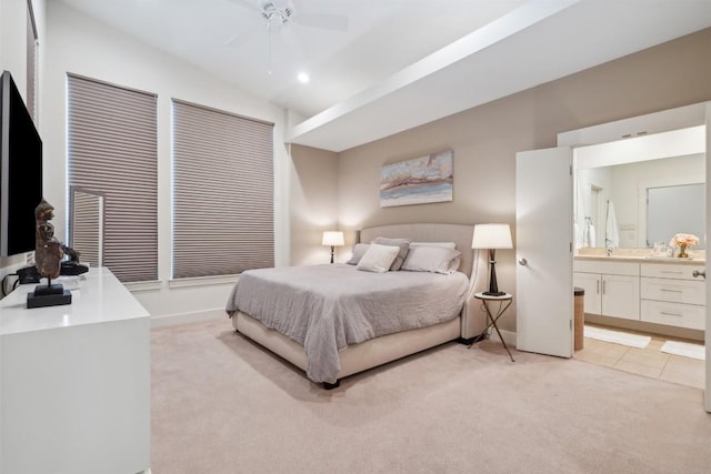 carpeted bedroom with ceiling fan and ensuite bathroom