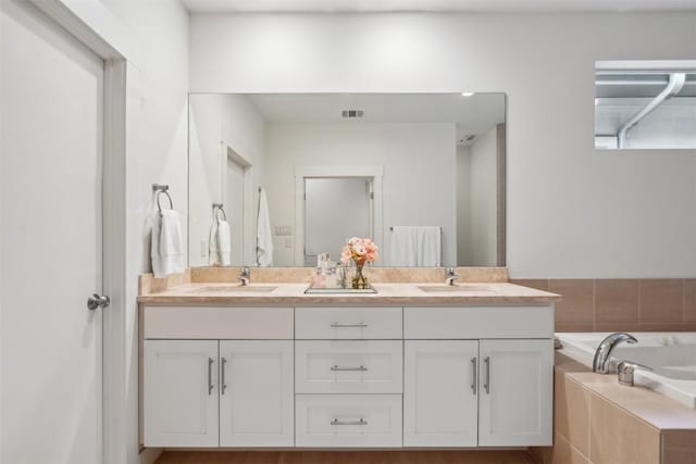 bathroom featuring a sink, visible vents, and double vanity