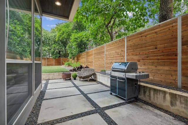 view of patio / terrace with grilling area and a fenced backyard