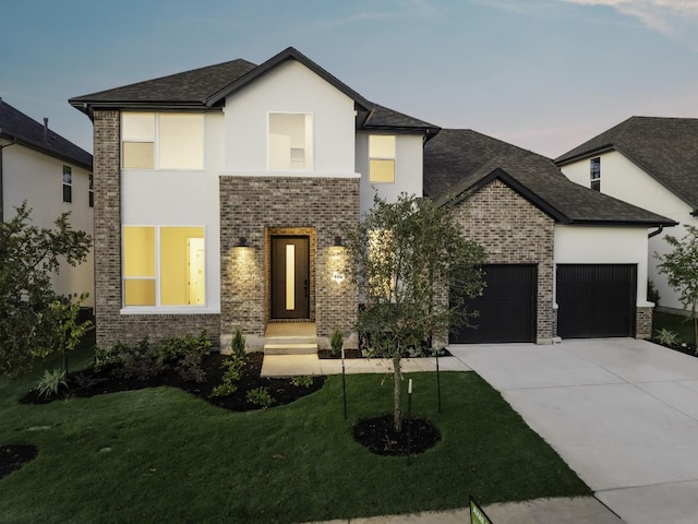 view of front facade with a lawn and a garage