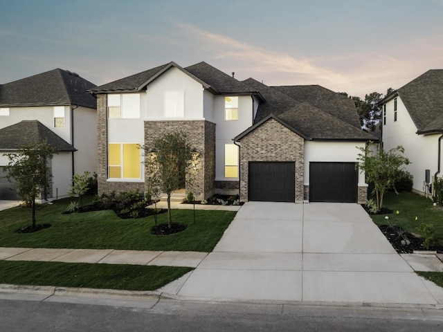 view of front of home featuring a yard and a garage