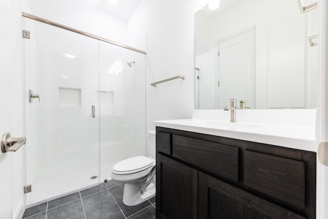 bathroom featuring tile patterned flooring, vanity, an enclosed shower, and toilet