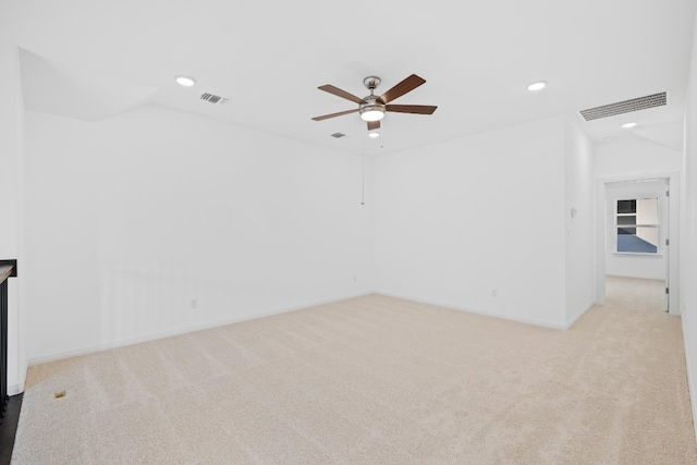 carpeted spare room with ceiling fan and lofted ceiling