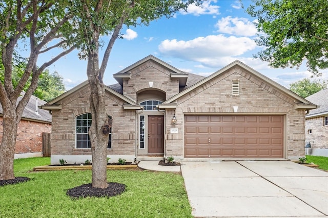 view of front of house featuring a garage and a front yard