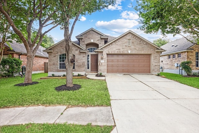 view of front of property featuring a garage and a front lawn