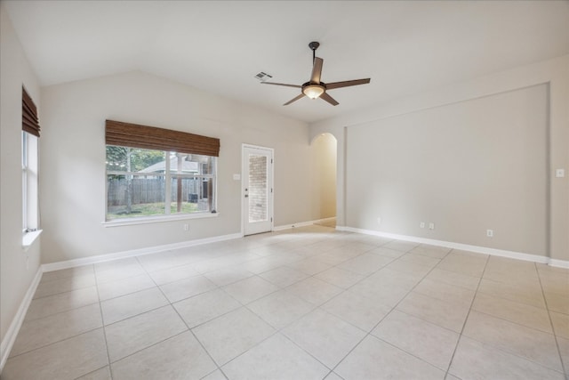 spare room featuring ceiling fan, light tile patterned flooring, and vaulted ceiling