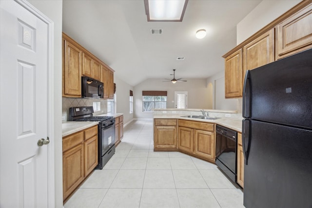 kitchen featuring backsplash, black appliances, sink, vaulted ceiling, and ceiling fan