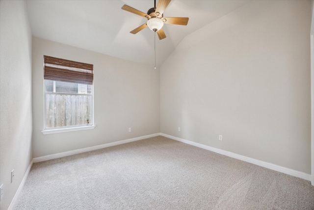 empty room with carpet floors, vaulted ceiling, and ceiling fan