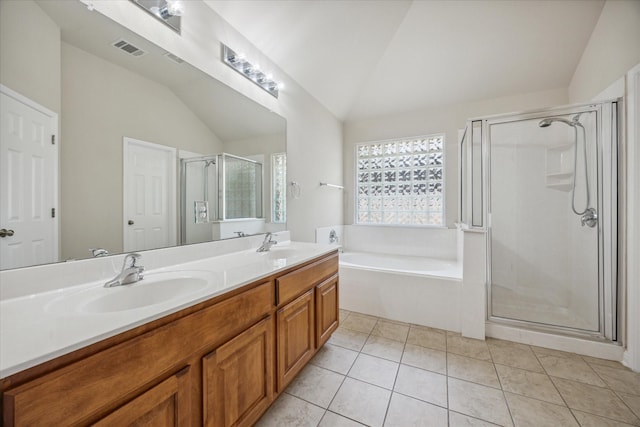 bathroom featuring tile patterned floors, vanity, vaulted ceiling, and separate shower and tub